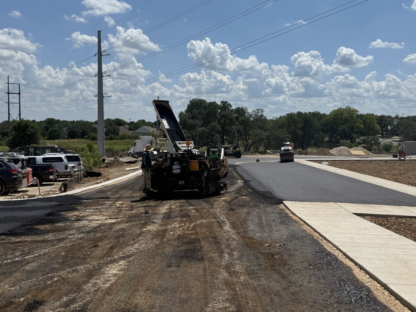 Paving machine laying asphalt, Avenue N commercial site work