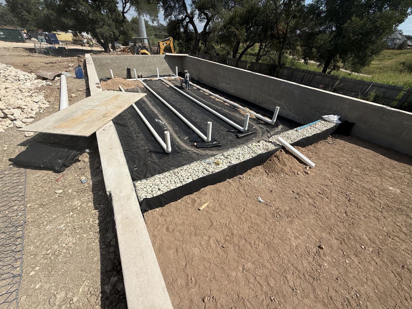 Drainage pipe and grading behind the wall, Avenue N commercial site work