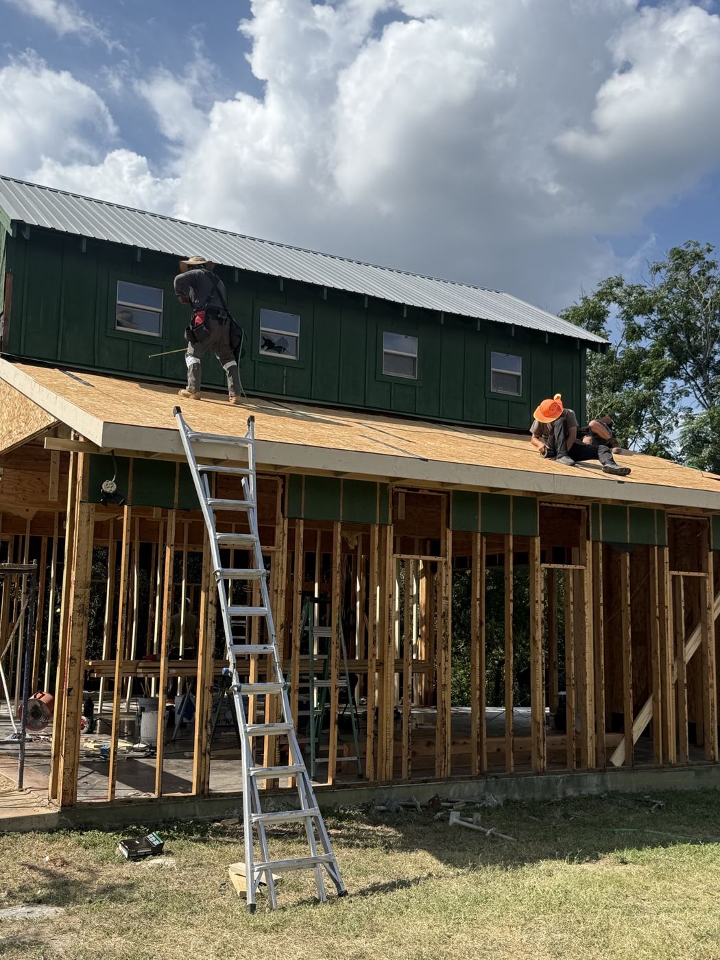 Crew on the roof over the new framing, barn remodel on El Viejo Camino in Austin