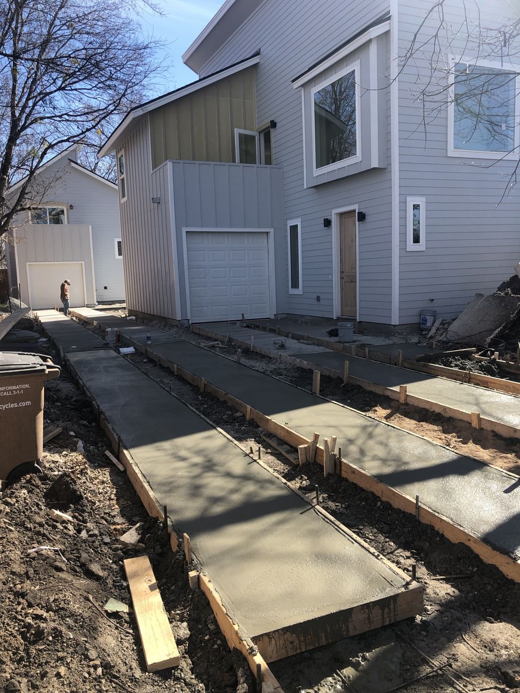 Driveway concrete poured between units, Vargas Street condos design-build in Austin
