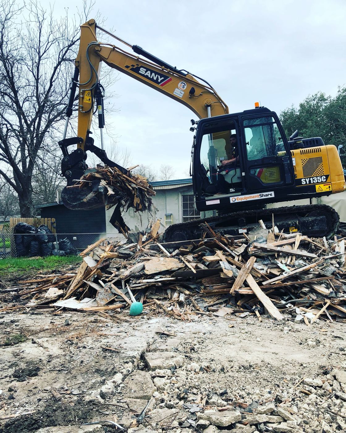 Clearing demolition debris, Vargas Street condos design-build in Austin