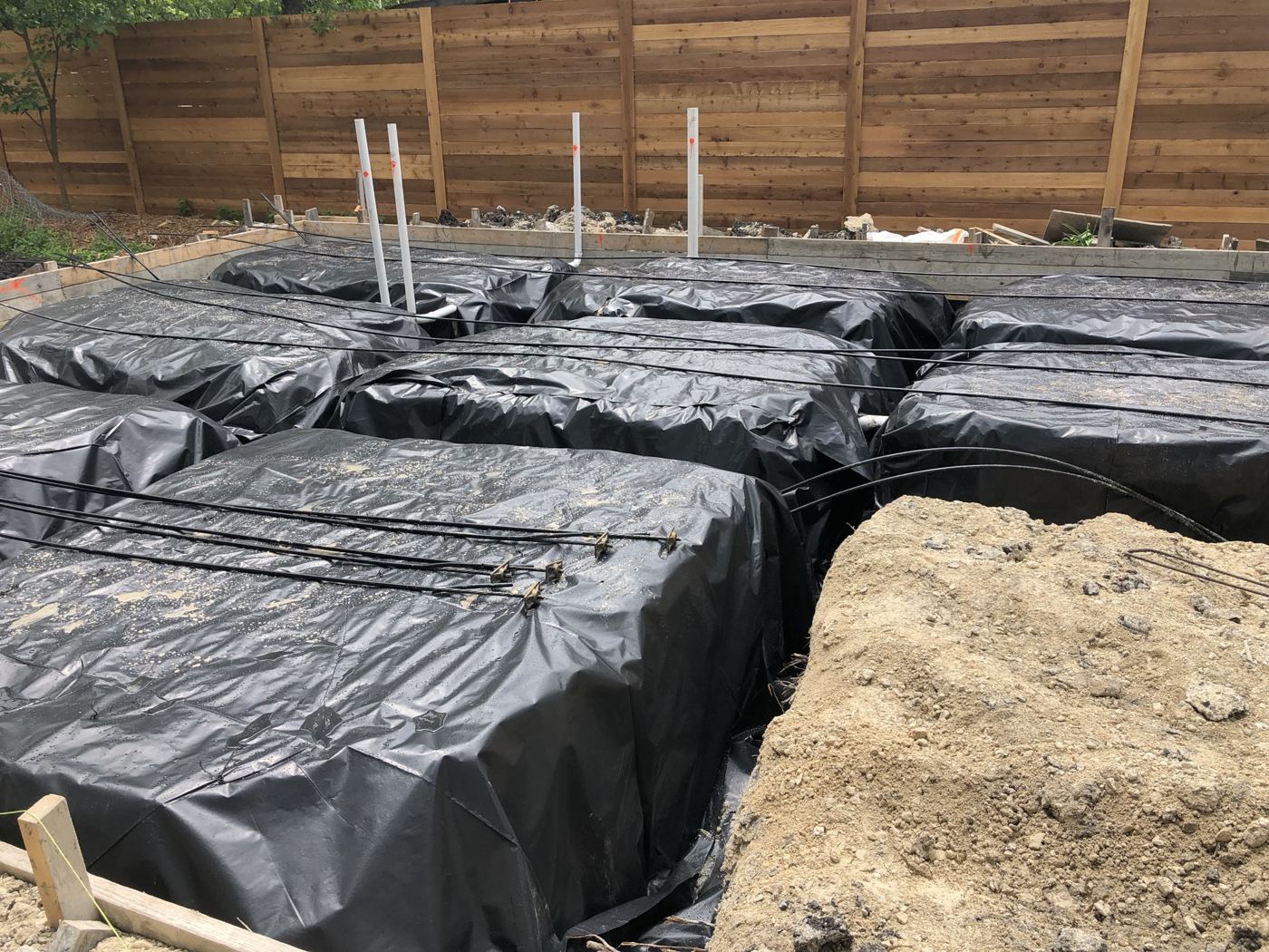 Vapor barrier and form boxes before the pour, Vargas Street condos design-build in Austin