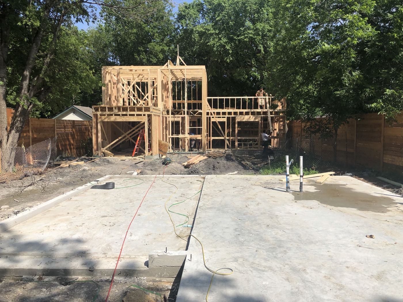 Finished slab with framing starting on the second unit, Vargas Street condos design-build in Austin