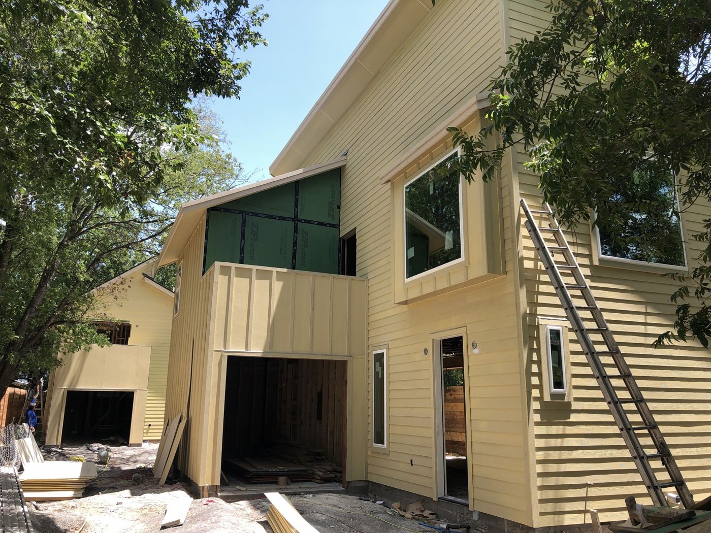 Siding and trim installed, Vargas Street condos design-build in Austin