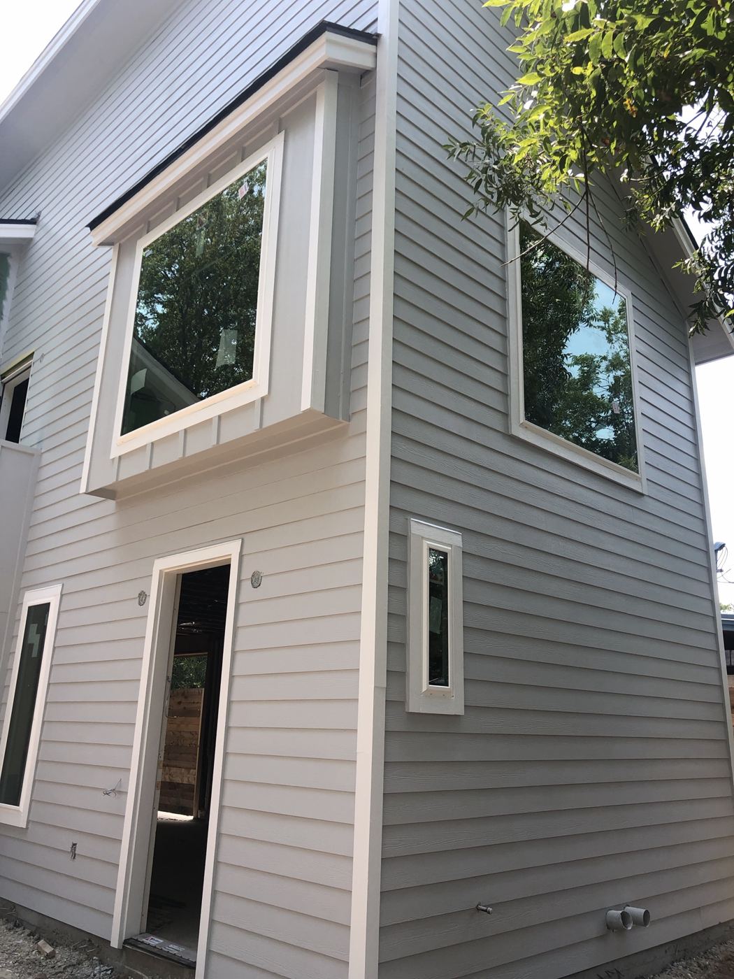 Finished exterior with siding and trim, Vargas Street condos design-build in Austin